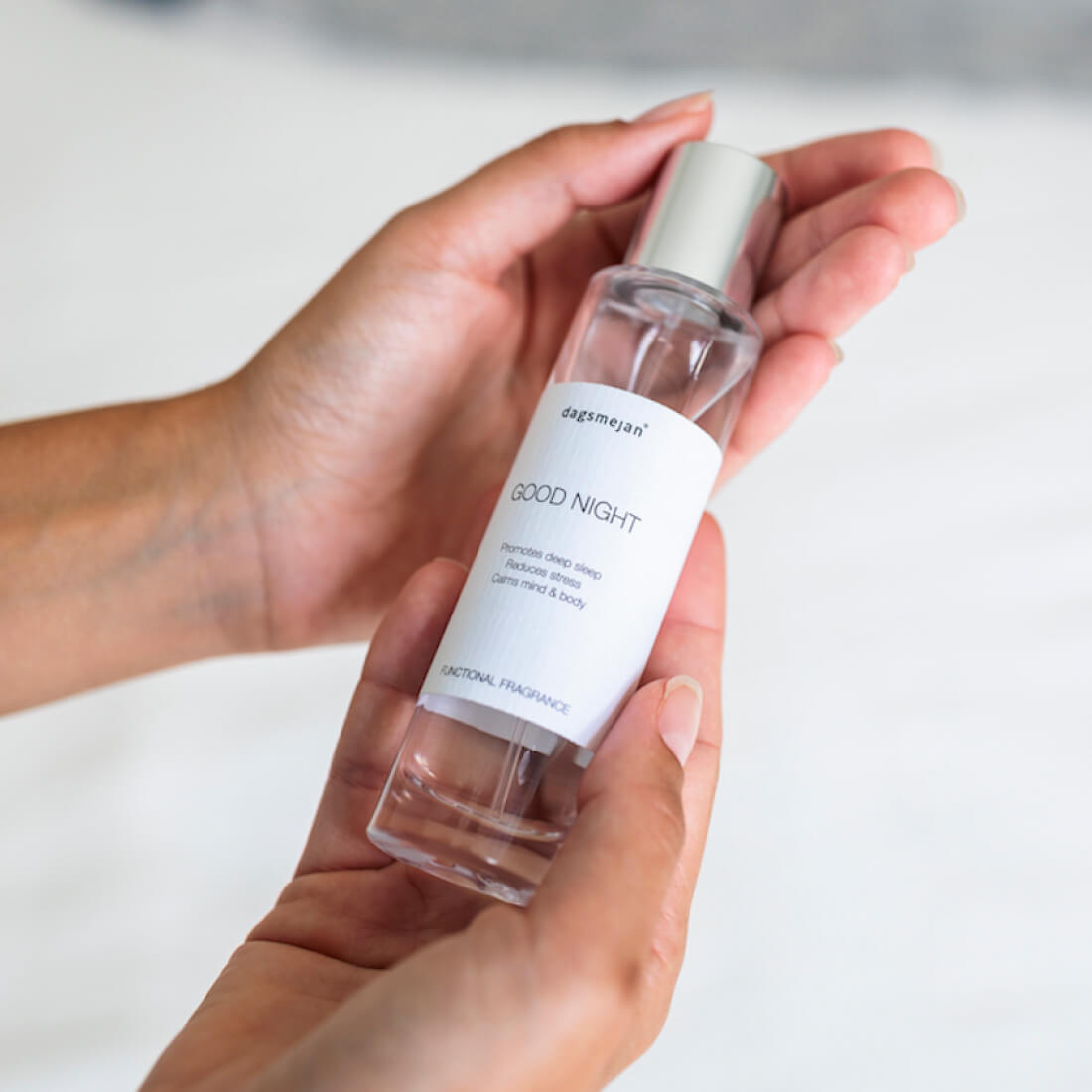 Hand holding a 'Good Night' fragrance bottle with a white label. || Lavender